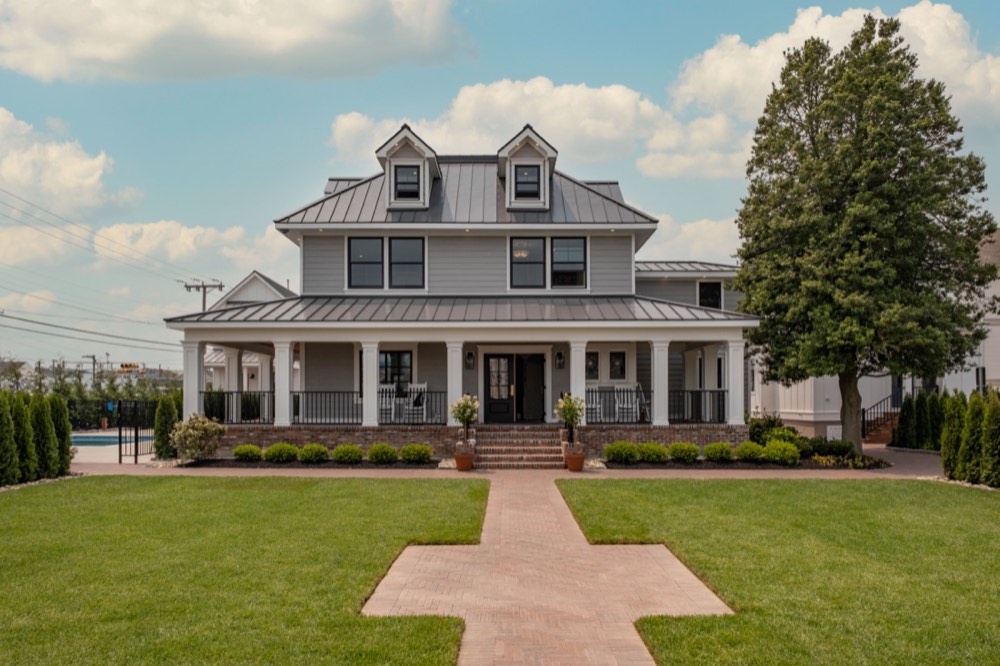 Front exterior of a Hen Houses property with wraparound porch