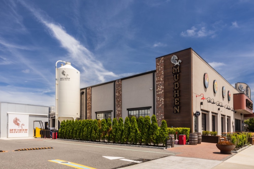 MudHen Brewing Company building with its brewing silo against a blue sky