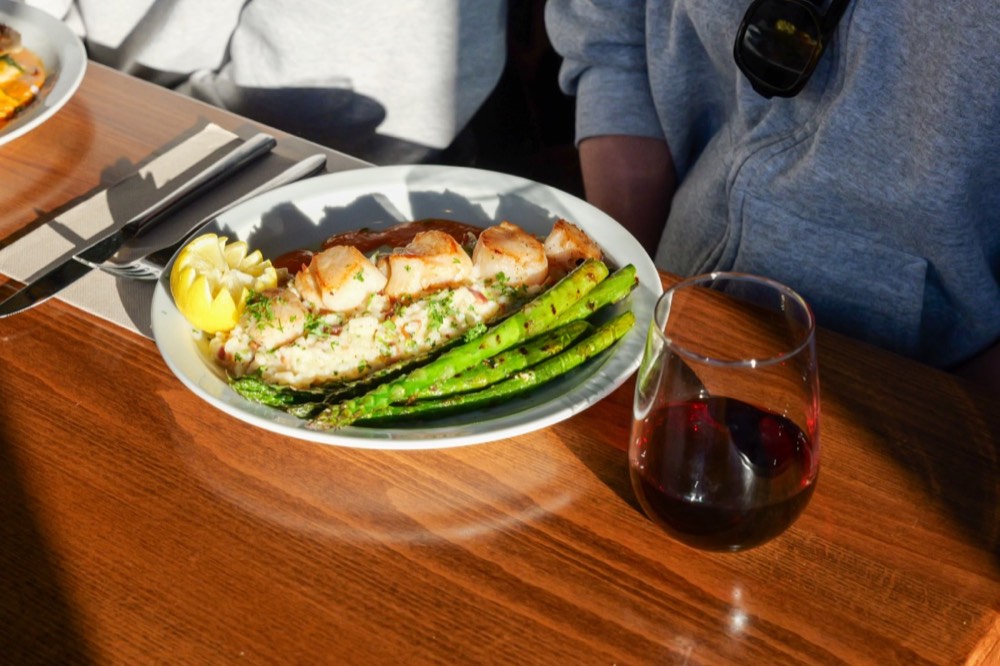 Grilled salmon with asparagus and a glass of red wine at Poppi's