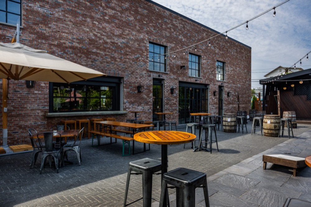Outdoor patio strung with lights beside the stage at The Station House