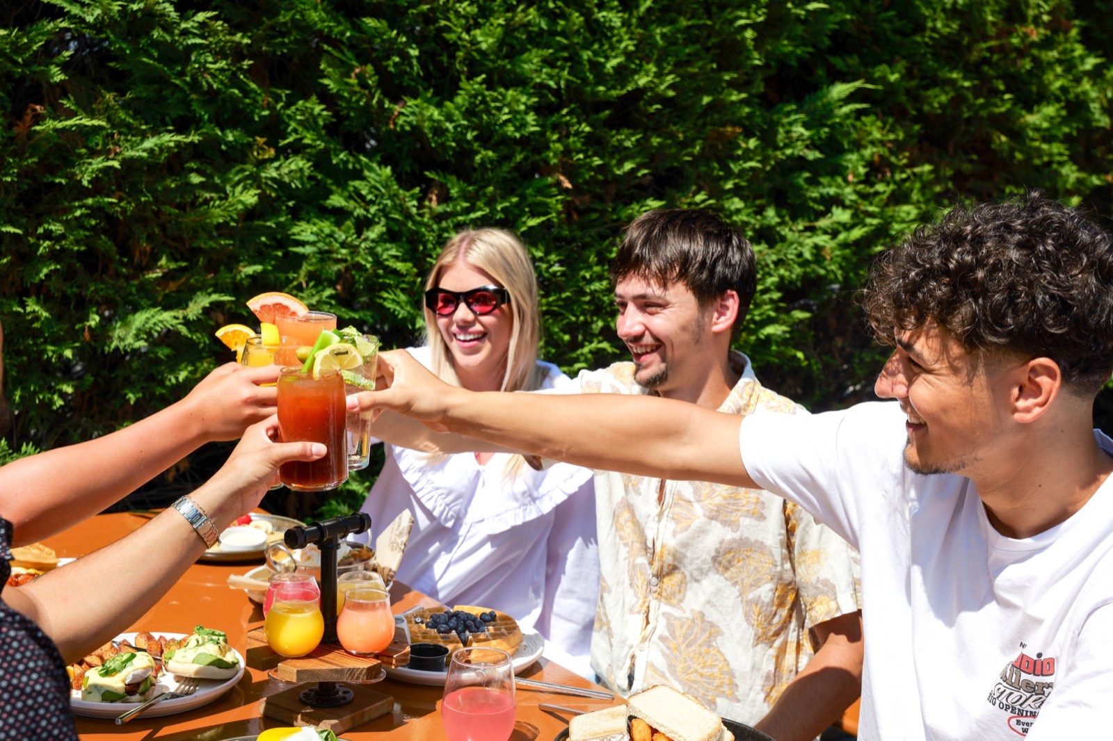Friends raising a toast over brunch at The Station House